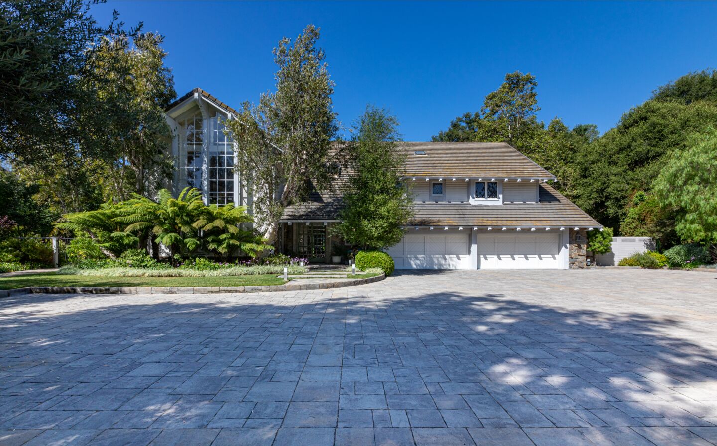 The 1.3-acre estate includes a five-bedroom home, tennis court, swimming pool and spa.