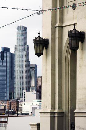 A light tower on the 4th Street Bridge displays the detail and ornate light fixtures that are hallmarks of many of the bridges spanning the Los Angeles River east of downtown. In the background is the U.S. Bank Tower, the tallest building on the West Coast.