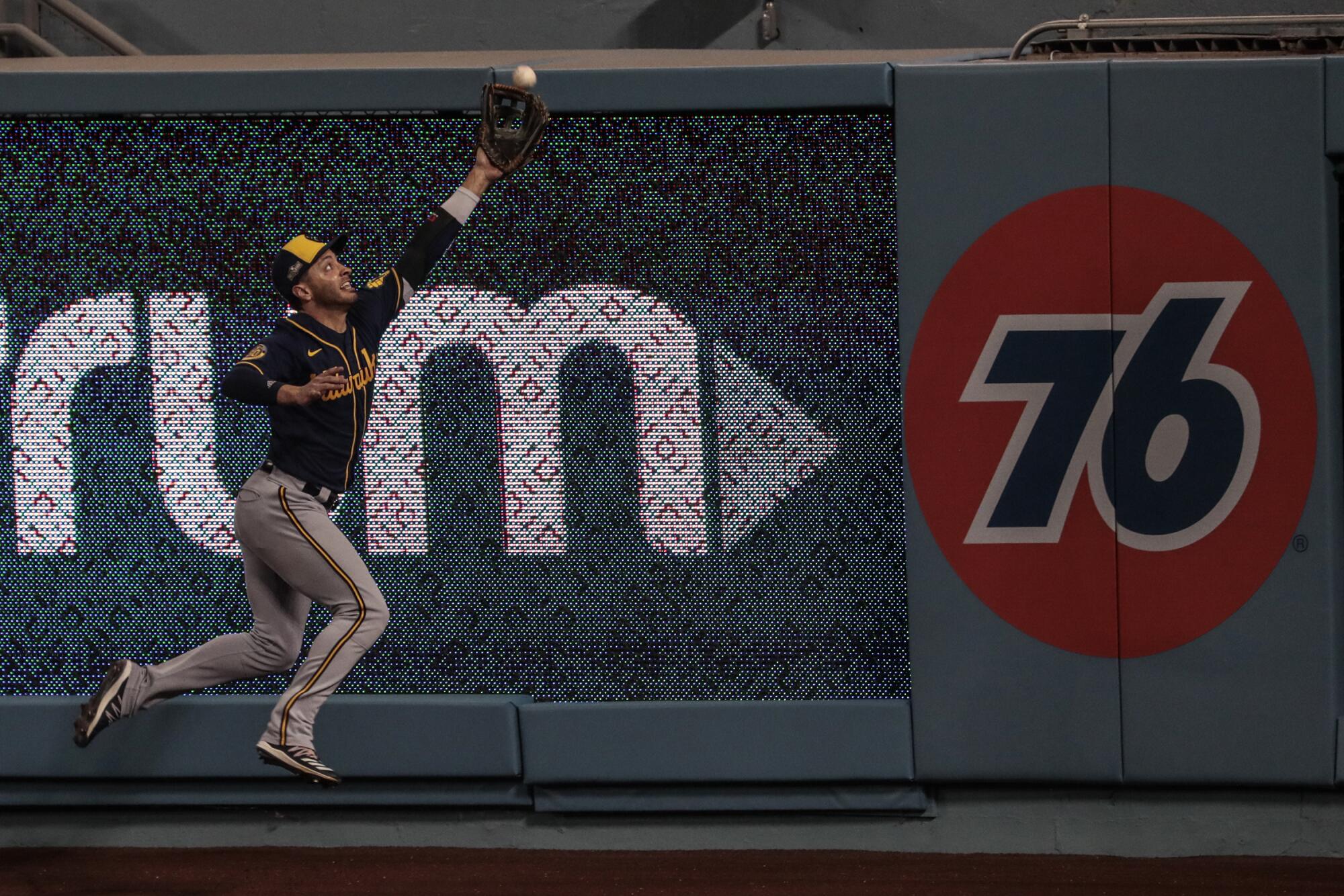 Milwaukee Brewers outfielder Ryan Braun misses a hit by Mookie Betts during the first inning.