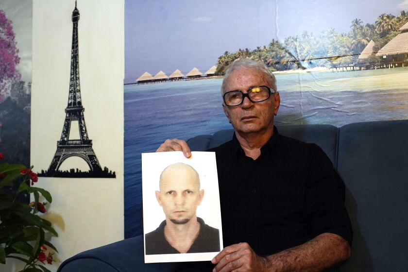 FILE - Nelson Faria Marinho shows a picture of his son Nelson Marinho, who lost his life in the 2009 Air France flight 447 accident, during an interview at his home in Rio de Janeiro, Brazil, on Sept. 5, 2019. Families of the 228 people killed aboard a Rio-Paris flight that crashed in 2009 were hoping for justice at last. Instead, they're wracked with anger and disappointment as a long-awaited trial wraps up Thursday, Dec. 8, 2022, with little hope that anyone will be held accountable. (AP Photo/Silvia Izquierdo)