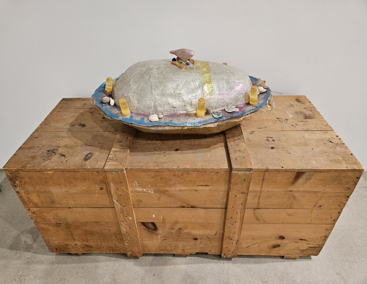 Barbara T. Smith's 1971 mold for a cast-resin sculpture of a huge squash sits on a wooden box