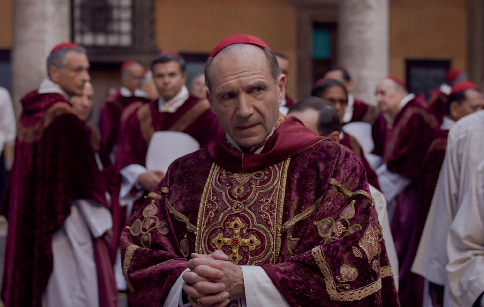 A Catholic cardinal in church robes considers weighty papal matters in "Conclave."