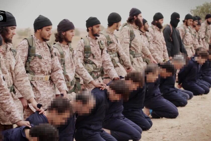 An image grab from a propaganda video released Sunday shows Islamic State extremists preparing to execute 15 Syrian soldiers.