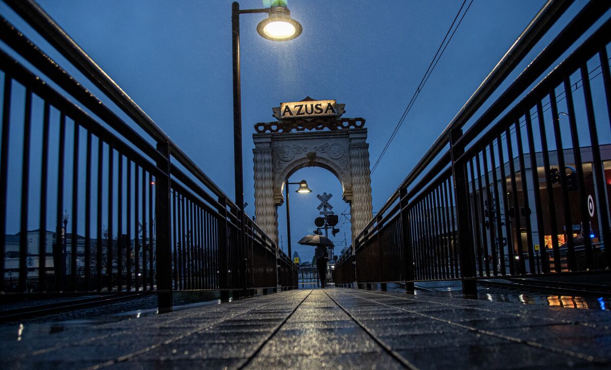 a wet sidewalk against a dark, rainy sky