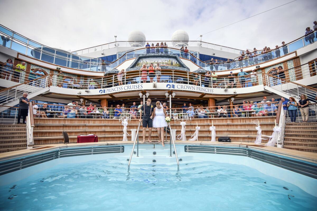 Bride Tami Van Dusen is escorted into a pool aboard the Crown Princess to wed Tim Ashley.