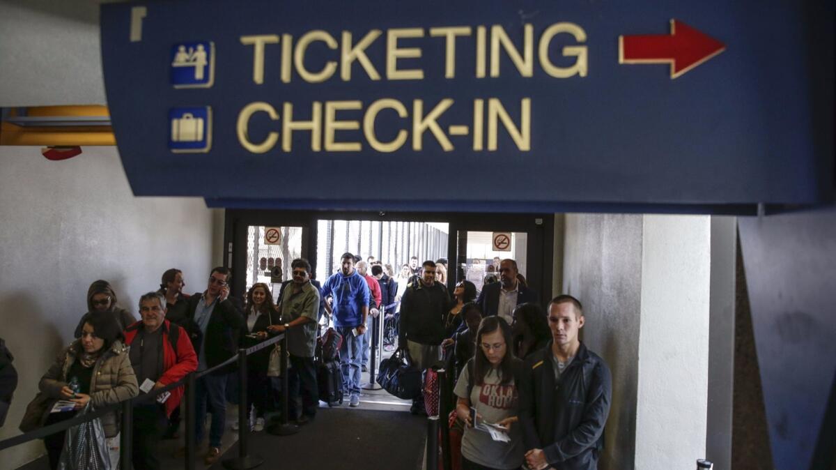 Travelers line up at a TSA checkpoint at LAX.