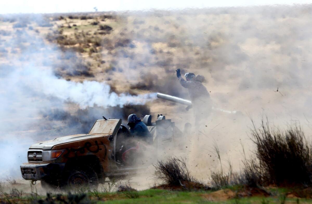 Fighters from the Libya Dawn militia fire a vehicle-mounted anti-tank cannon in a clash with forces loyal to Libya's internationally recognized government near the Wetia air base on Dec. 30.