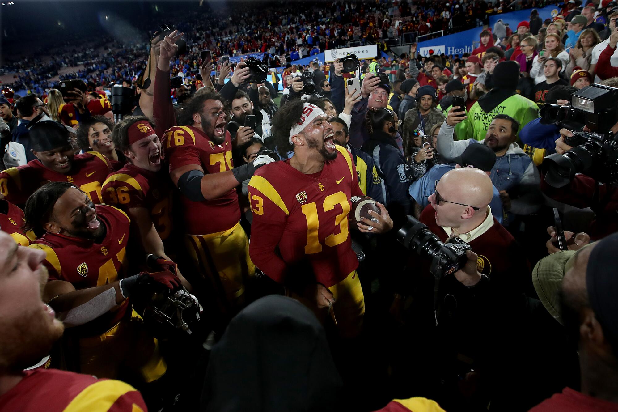 USC quarterback Caleb Williams, center, celebrates with teammates after a 48-45 win over crosstown rival UCLA.