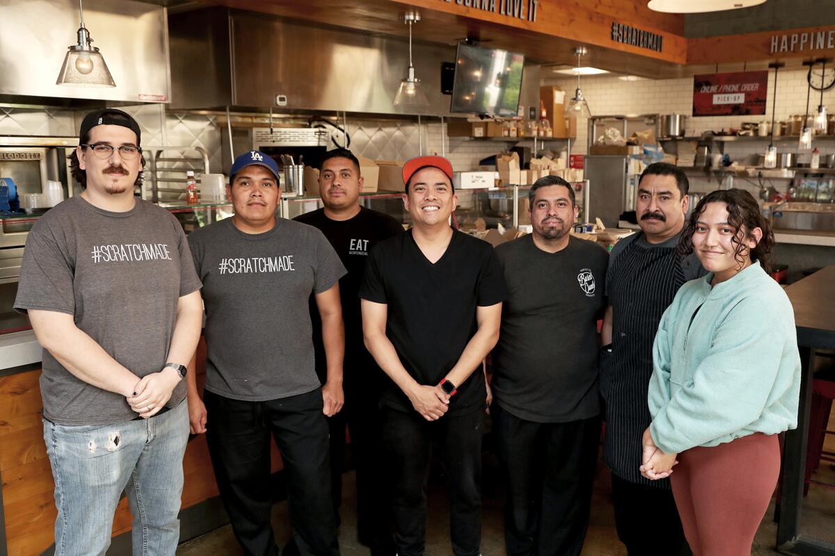 Chef/owner Paul Cao, center, and employees at Burnt Crumbs in Irvine. 