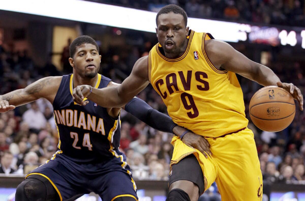 Cavaliers forward Luol Deng drives past Pacers forward Paul George in Cleveland.