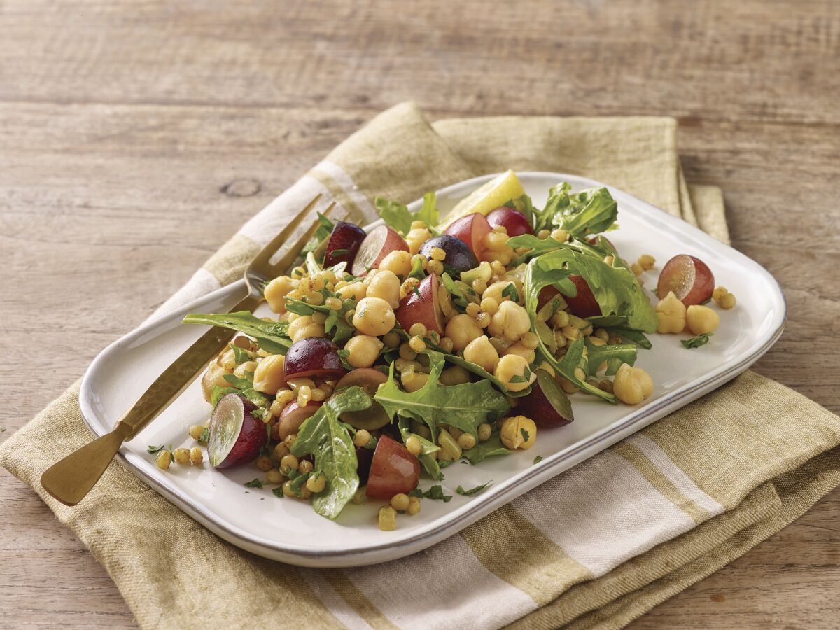 Warm spiced chickpeas and couscous with grapes and arugula