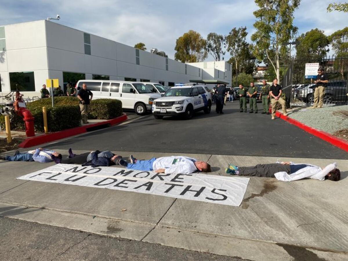 Doctors and other activists protest Tuesday outside the Border Patrol San Diego Sector headquarters in Chula Vista.