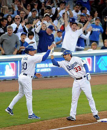 Dodgers second baseman Blake DeWitt gets a high-five from third base coach Larry Bowa after delivering a three-run triple in the first inning Sunday.