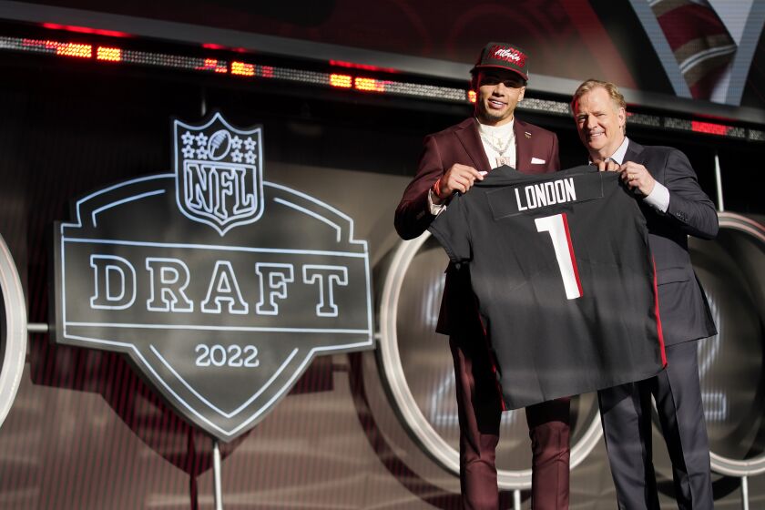 Southern California wide receiver Drake London stands with NFL Commissioner Roger Goodell.