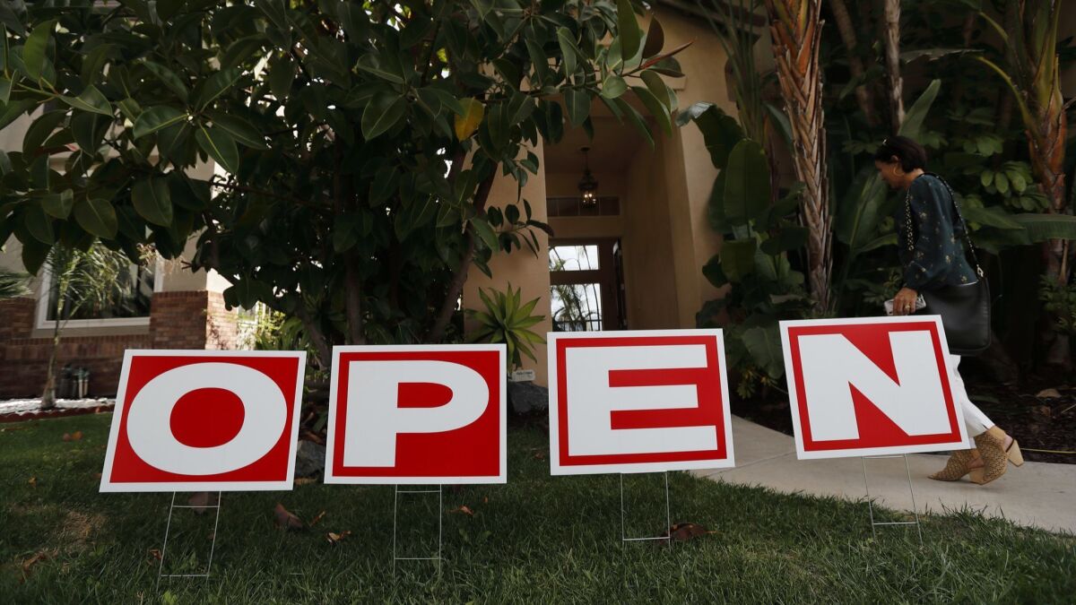 A lawn sign advertises an open house for a home for sale in Chula Vista, Calif. in October.