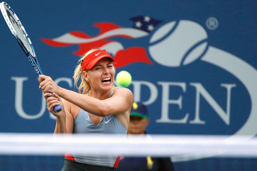 FILE - In this Aug. 27, 2014, file photo, Maria Sharapova, of Russia, returns a shot to Alexandra Dulgheru, of Romania, during the second round of the U.S. Open tennis tournament, in New York. Sharapova has been granted a wild-card invitation for the U.S. Open's main draw. Sharapova is among eight women who were given entry into the 128-player field by the U.S. Tennis Association on Tuesday, Aug. 15, 2017, and by far the most noteworthy. (AP Photo/Jason DeCrow, File)