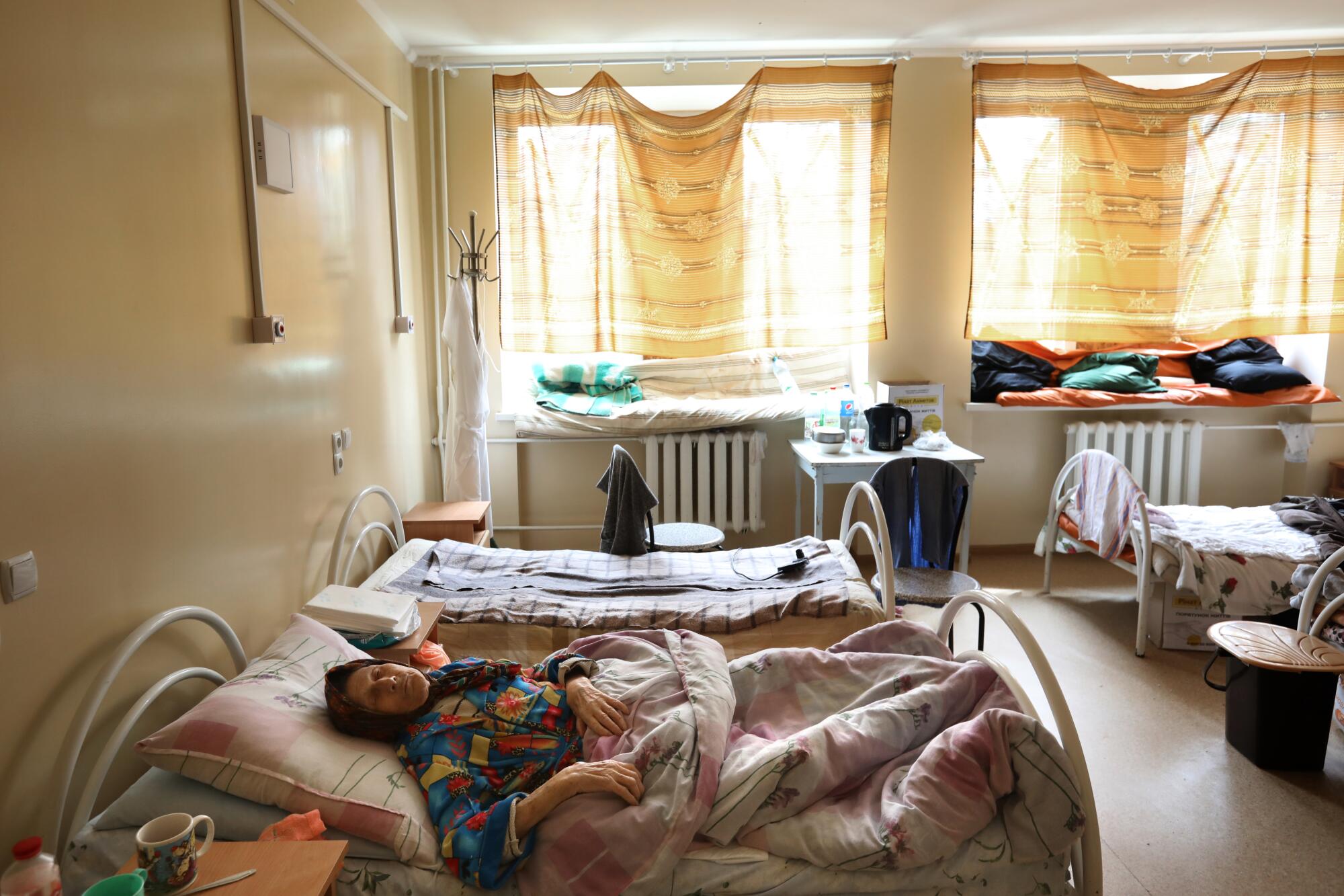 At a frontline hospital in Severndenesk, Ukraine, a partially blind woman rests.