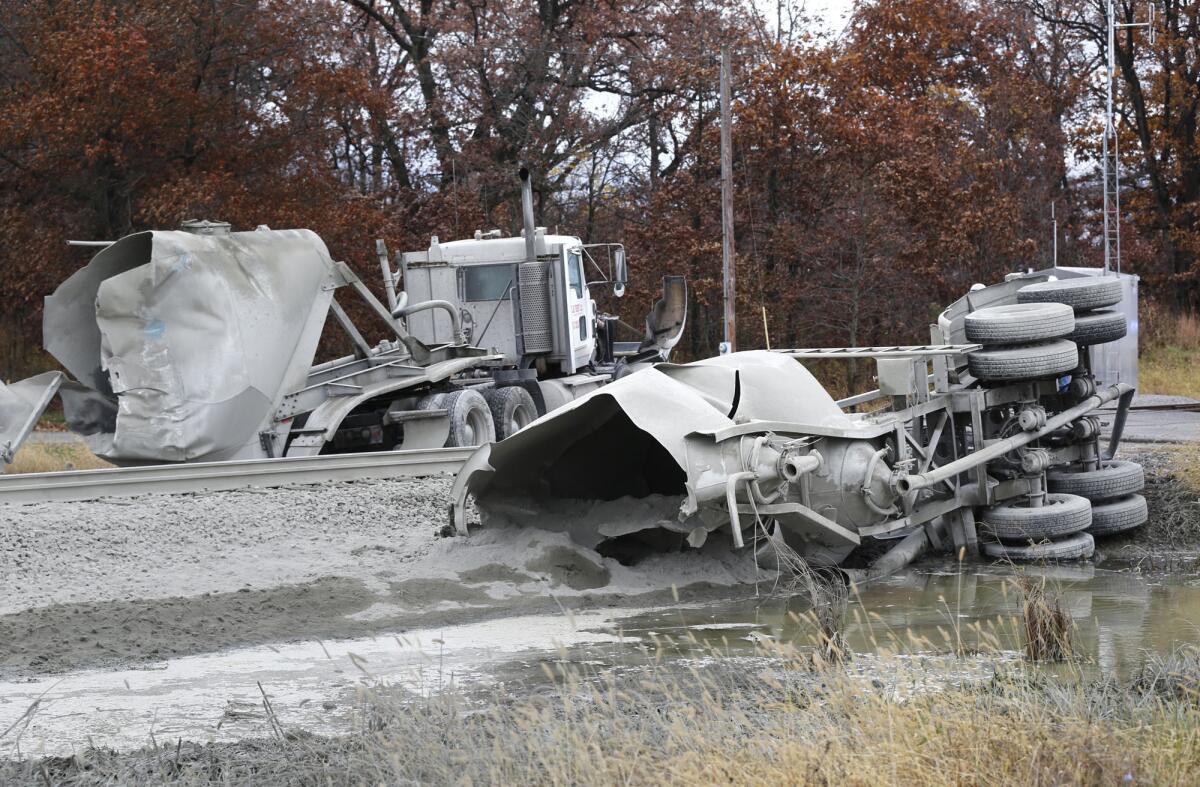 A semi-truck hauling cement lies in two pieces after an Amtrak train struck it about 8:30 a.m. Tuesday, Oct. 28, 2014, just east of the intersection of White County Road 200 North and Indiana 421 near Reynolds, Ind. The train was northbound and heading to Chicago when the accident took place. White County Sheriff Pat Shafer said 14 people complaining of pain were taken to local hospitals after the collision. The truck driver was not among the injured, he said. (AP Photo/Journal & Courier, John Terhune)