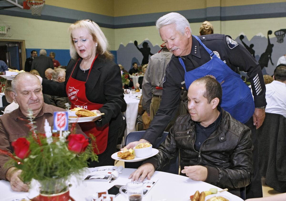Outgoing Glendale police chief Ron DePompa, right, helped serve breakfast for others at the 5th annual Kettle Kick Off Breakfast at the Salvation Army Glendale Corps Community Center in Glendale on Friday, Nov. 22, 2013.