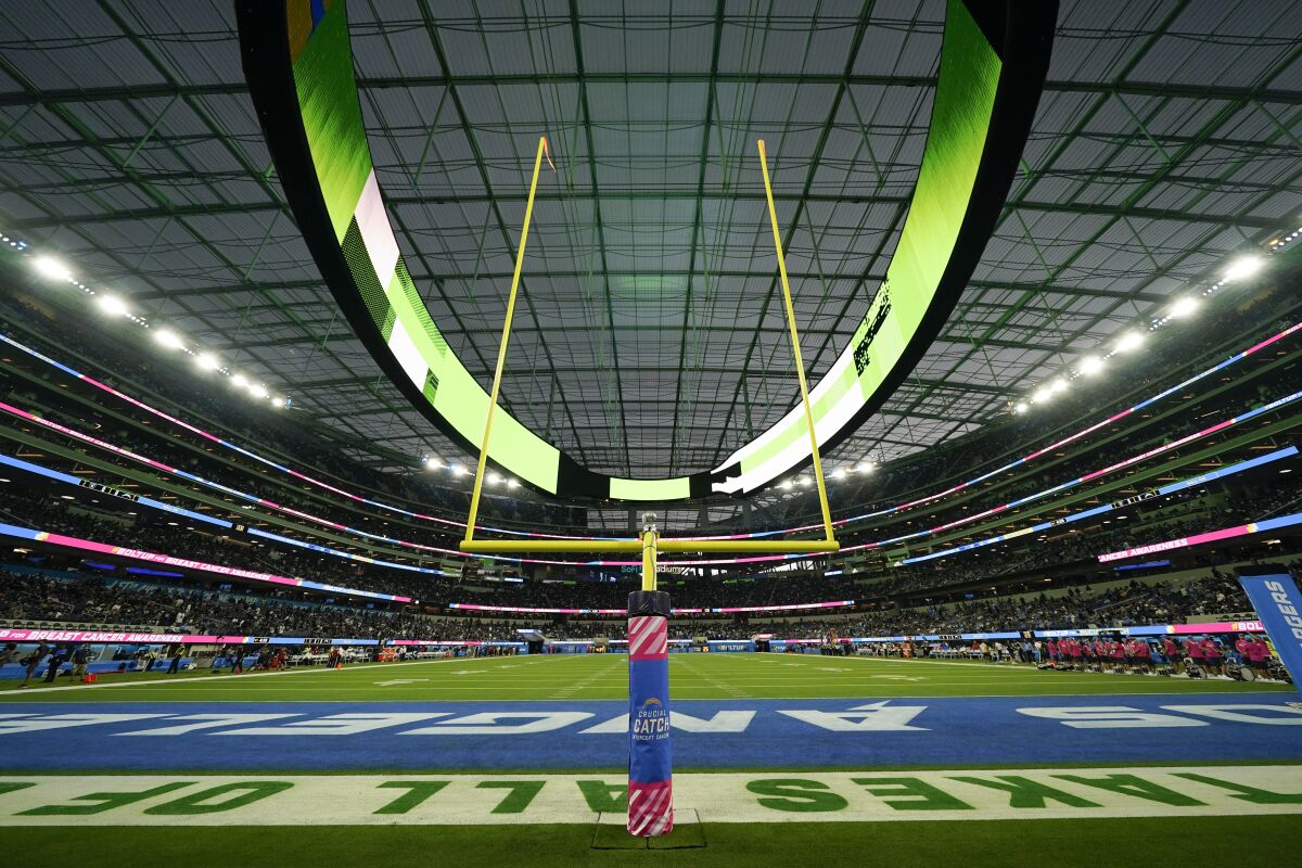 The field at SoFi Stadium sits empty during a weather delay shortly before the scheduled start of an NFL football game between the Los Angeles Chargers and the Las Vegas Raiders, Monday, Oct. 4, 2021, in Inglewood, Calif. (AP Photo/Ashley Landis)