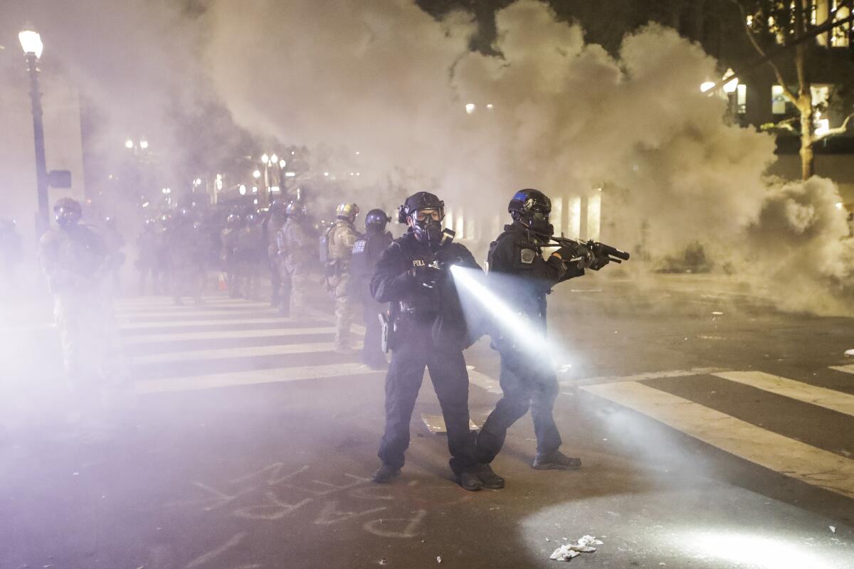 Federal officers deploy tear gas in Portland, Ore., on Tuesday