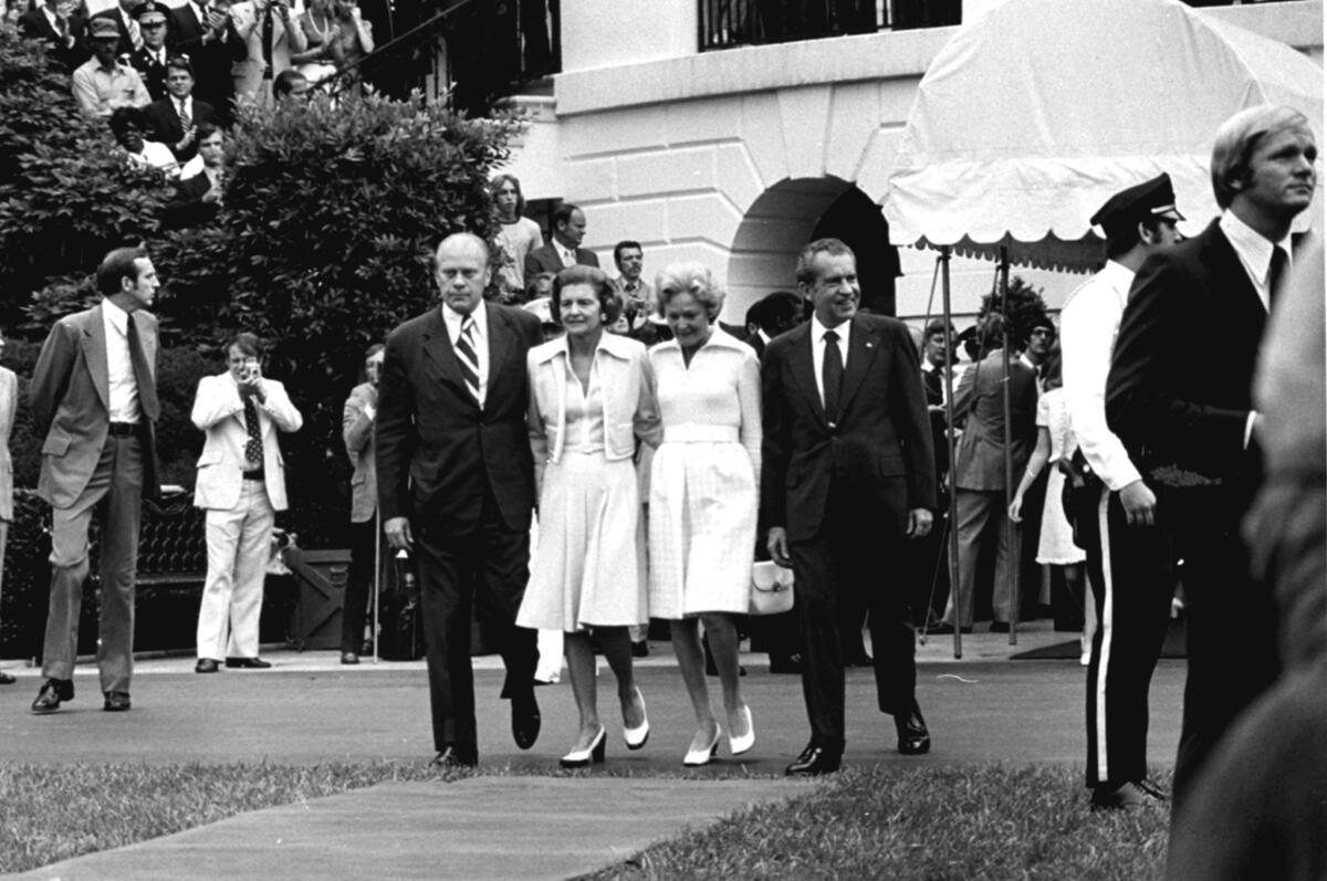 President Nixon and First Lady Pat Nixon are escorted from the White House by the Fords after Nixon's speech to the White House staff on the day he resigned.