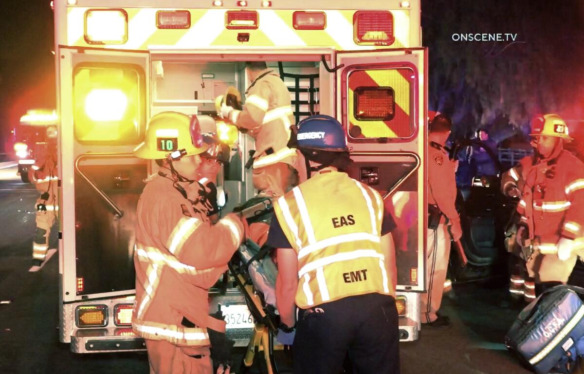 First responders load an injured Orange County sheriff's deputy into an ambulance in Yorba Linda.