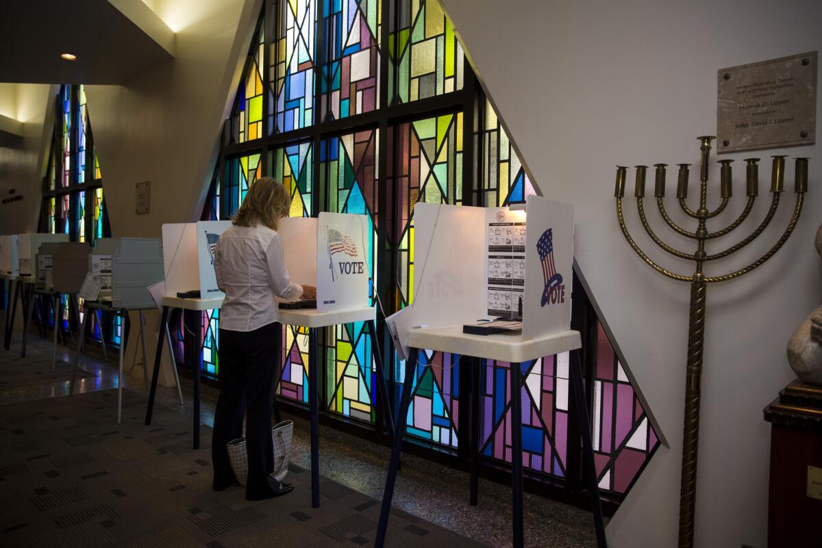 Cindy White of Westwood casts her vote at Sinai Temple on Wilshire Boulevard.