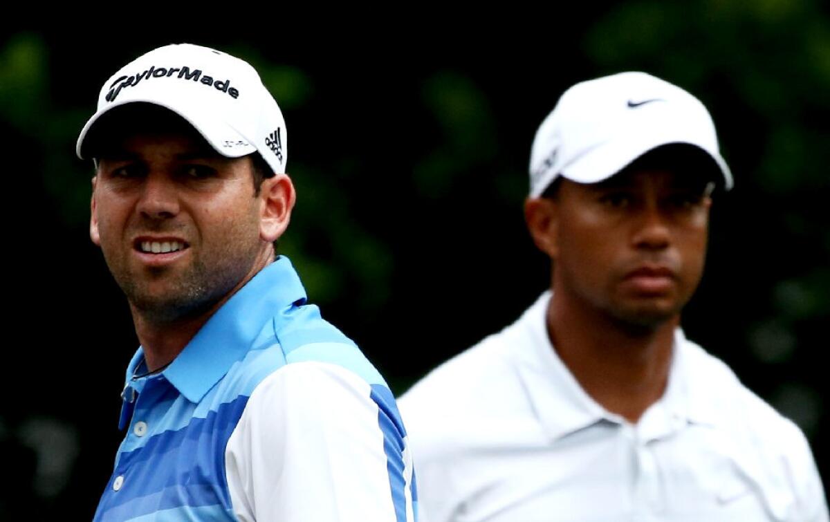 Tiger Woods and Sergio Garcia stand on the 11th tee during round three of The Players Championship.