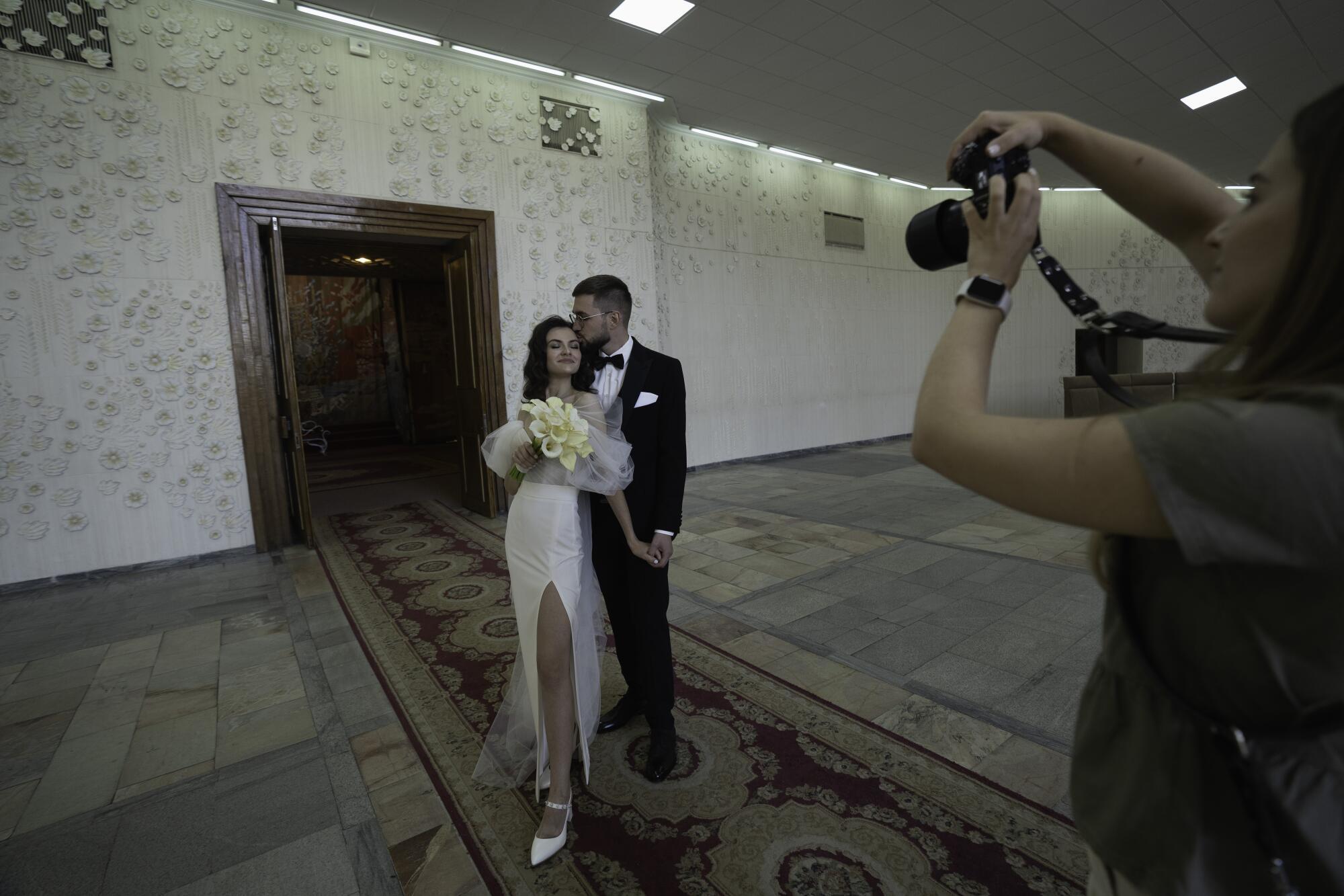 A couple is photographed after their wedding