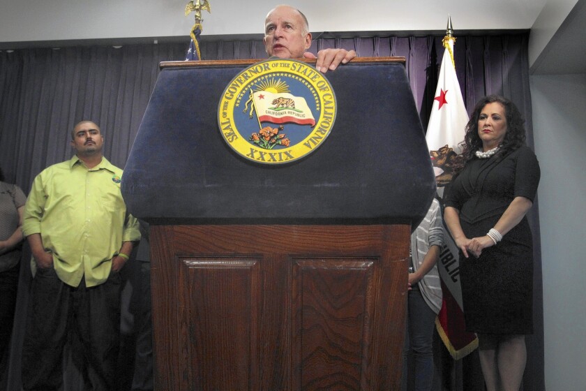 Gov. Jerry Brown speaks in Los Angeles before signing a bill that will require California employers to provide paid sick leave starting in July 2015.
