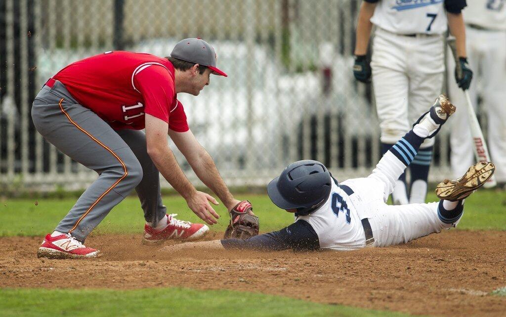 Corona del Mar's Lucas Ciachurski beats the tag at home against Woodbridge's pitcher Eric Cardillo.