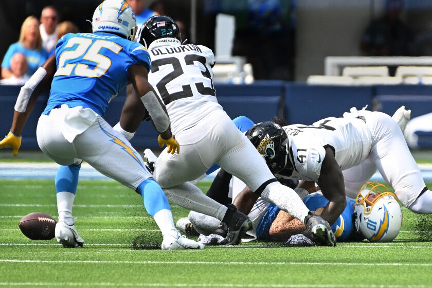 Inglewood, California September 25, 2022-Chargers quarterback Justin Herbert fumbles the ball to the Jaguars defense in the second quarter at SoFi Stadium Sunday. (Wally Skalij/Los Angeles Times)