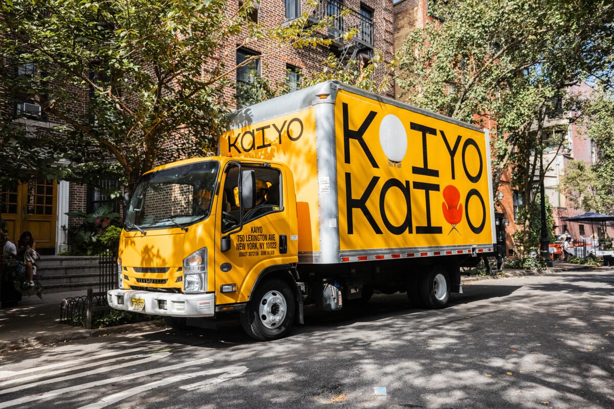 Yellow moving van with Kaiyo written on the side
