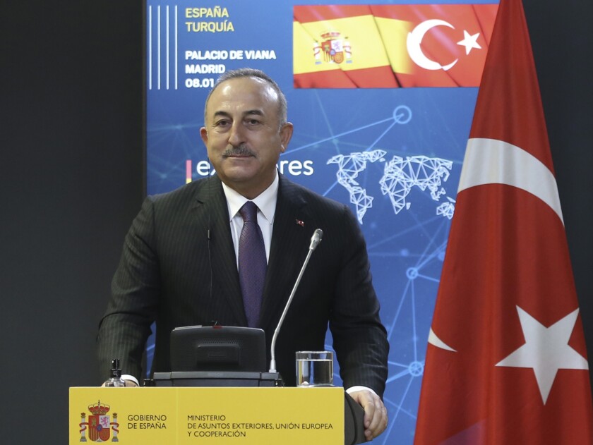 Turkish Foreign Minister Mevlut Cavusoglu speaks at a news conference in Madrid, Spain, Friday, Jan. 8, 2021. Turkey on Monday, Jan. 11 invited Greece to resume talks designed to reduce tensions between the neighbors, following this summer's dispute over maritime borders and energy rights in the eastern Mediterranean. Cavusoglu also extended an invitation to Greek Foreign Minister Nikos Dendias, for a meeting to discuss their troubled relations.(Turkish Foreign Ministry via AP, Pool)