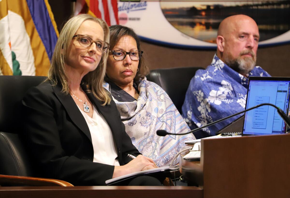 Huntington Beach City Council members listen to a speaker during Tuesday night's meeting.