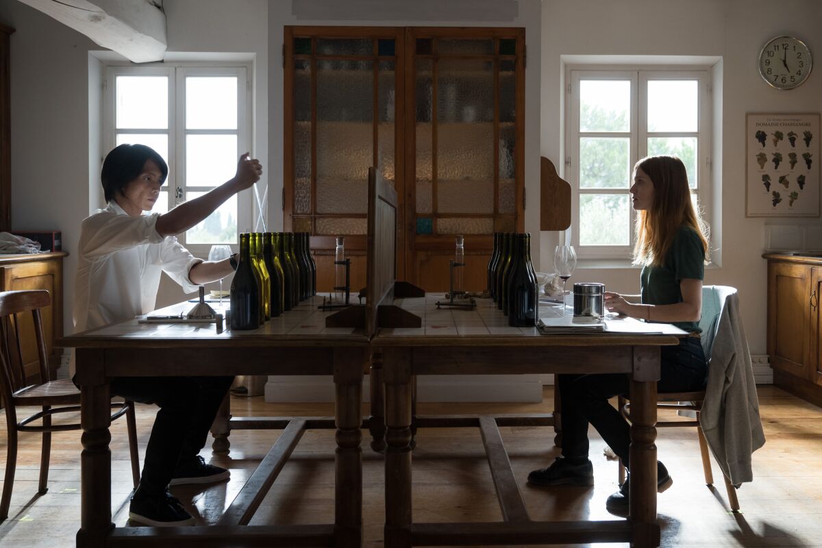 Two people face each other across a table.