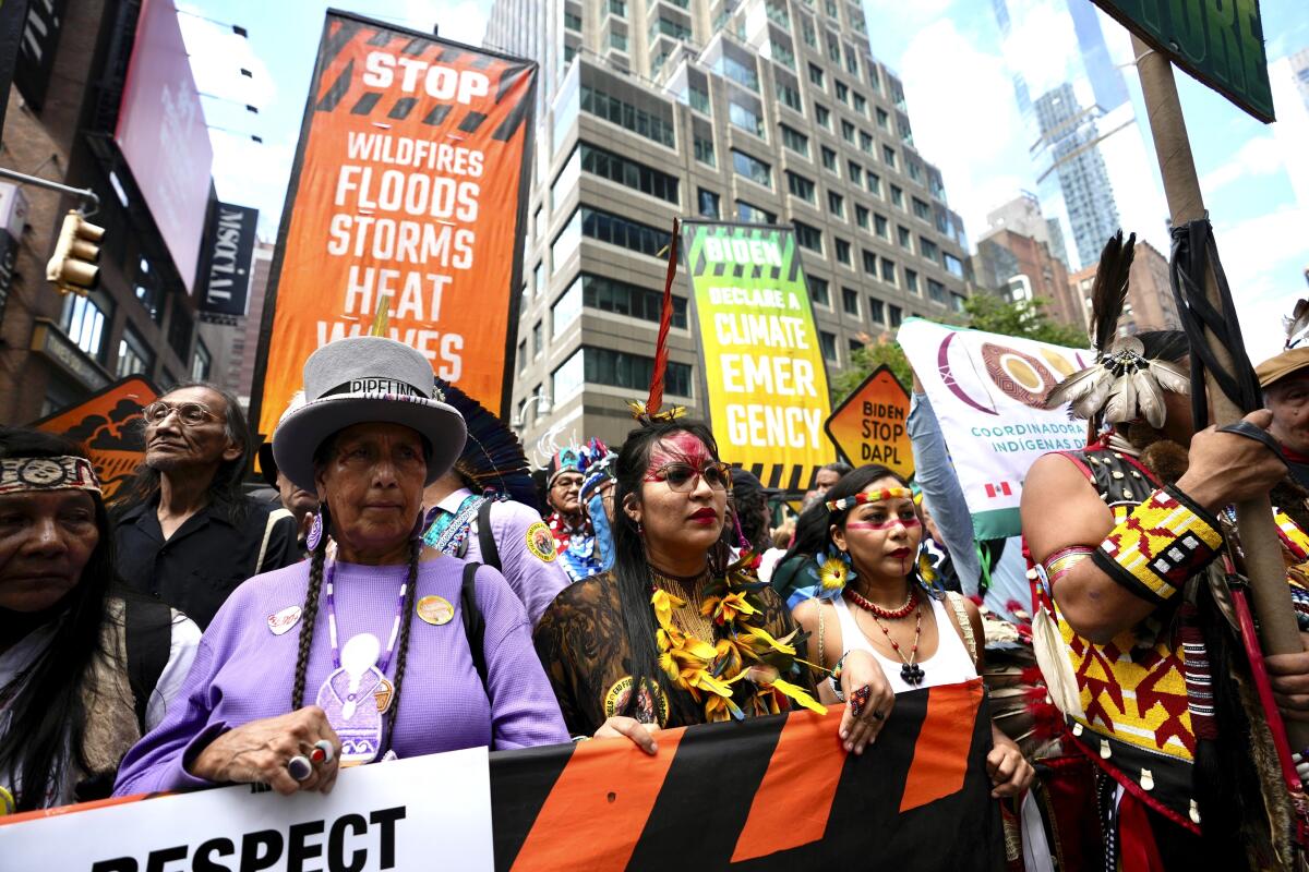 Climate activists march protesting energy policies and the use of fossil fuels, in New York on Sunday.