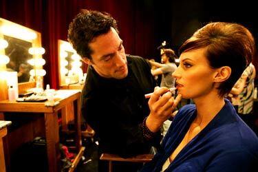 Makeup and hair artist Jeffrey Paul puts the finishing touches on model Sarah Happel before the Oscar fashion preview show at the Academy of Motion Picture Arts and Sciences building in Beverly Hills.
