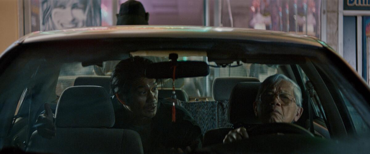 A still from "The Accidental Getaway Driver" shows two men in a cab.