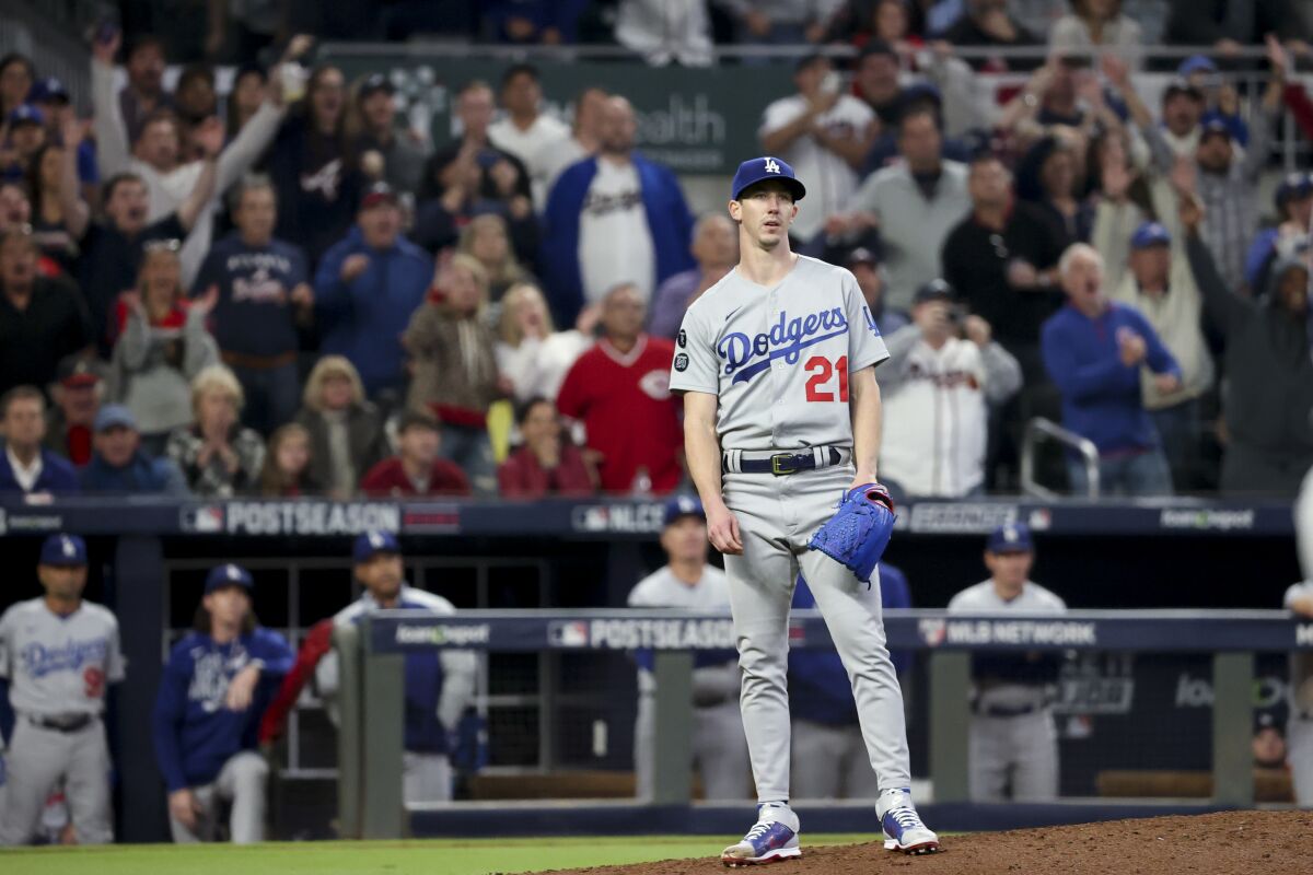 Dodgers pitcher Walker Buehler reacts after giving up a three-run home run against Atlanta on Oct. 23, 2021.