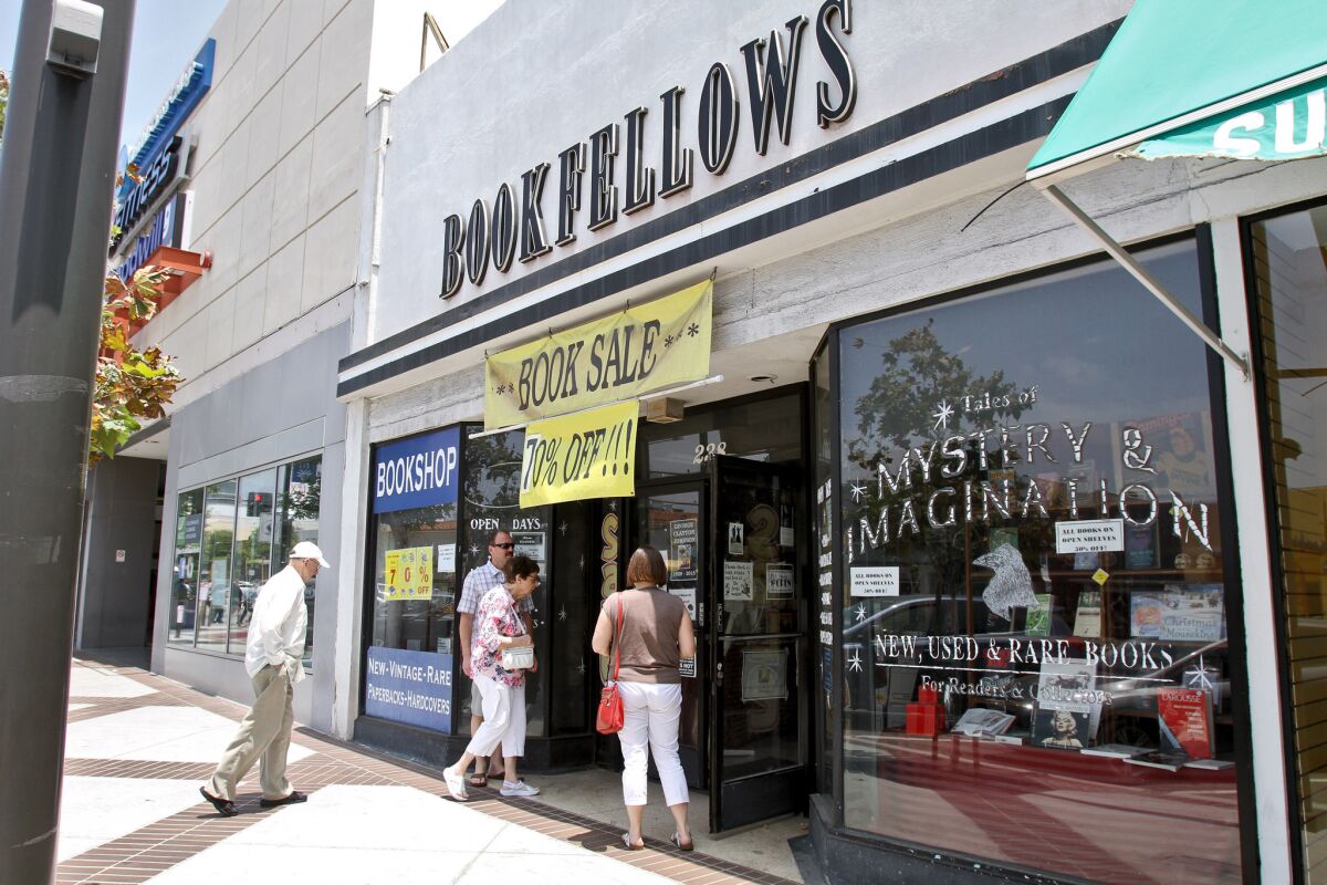 A steady flow of customers enter the Bookfellows bookstore on the 200 block of North Brand Boulevard.The store, which has been at this location for 17 years, will close soon and will become mail-order-only by the end of July.