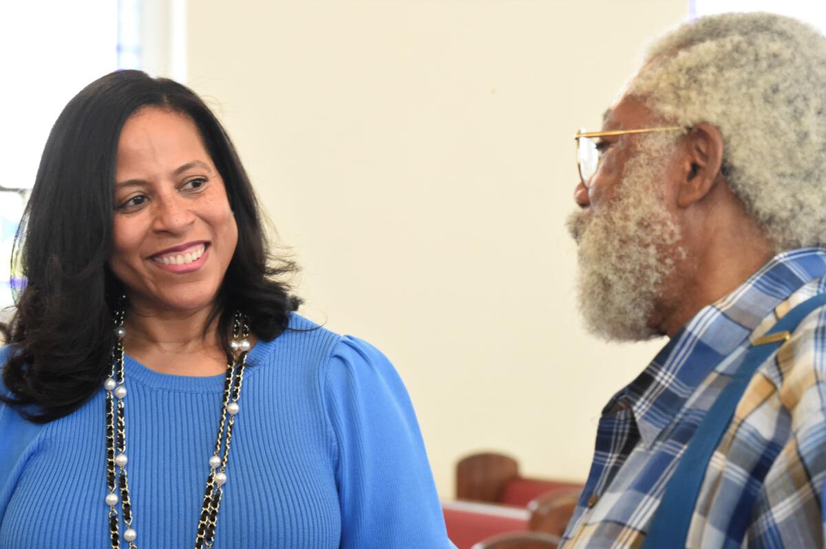 State Sen. Mia McLeod, left, stands in the sanctuary of Shiloh Baptist, her family's church, talking with Rev. Coley Mearite, Tuesday, June 1, 2021, in Bennettsville, S.C. In her challenge of Gov. Henry McMaster, the Columbia Democrat is the first Black woman to seek South Carolina's top job. (AP Photo/Meg Kinnard)