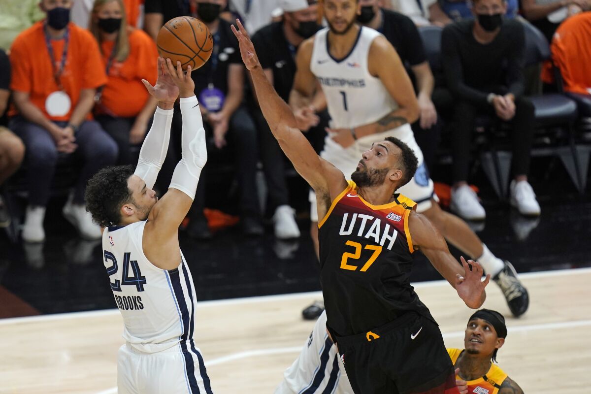 Utah Jazz center Rudy Gobert (27) blocks the shot of Memphis Grizzlies forward Dillon Brooks (24) during the first half of Game 5 of an NBA basketball first-round playoff series Wednesday, June 2, 2021, in Salt Lake City. (AP Photo/Rick Bowmer)