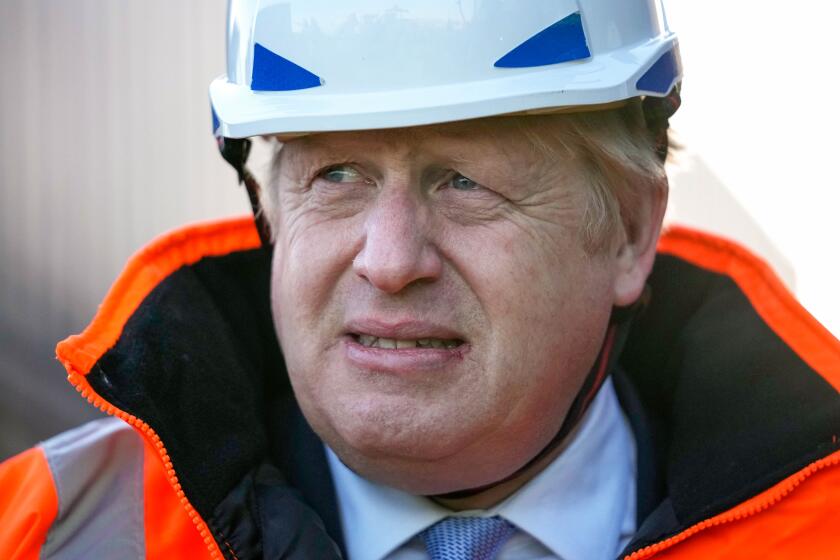 British Prime Minister Boris Johnson visits the Tilbury Docks in Tilbury, England, Monday, Jan. 31, 2022. 