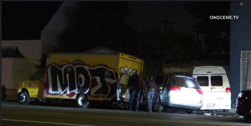 Police officers search the area where a naked man allegedly crashed a car after a chase.