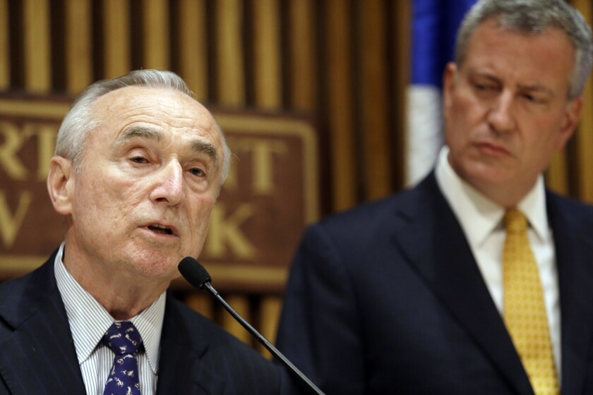 New York Police Commissioner William J. Bratton, left, announced the launch of a pilot program that will see 60 officers begin to wear body cameras.