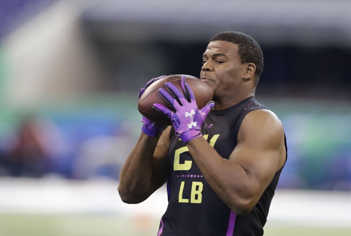 Virginia linebacker Micah Kiser catches a pass during a drill at the NFL scouting combine.