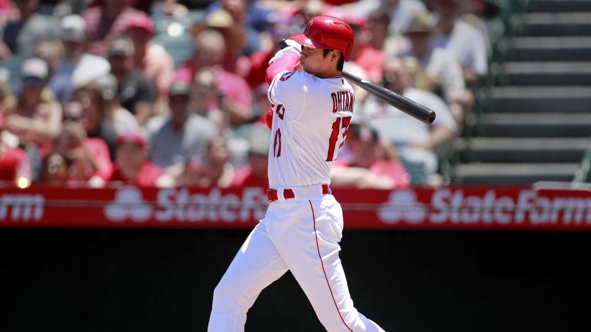 The Angels' Shohei Ohtani hits a single in the second inning against the Texas Rangers at Angel Stadium on June 3.