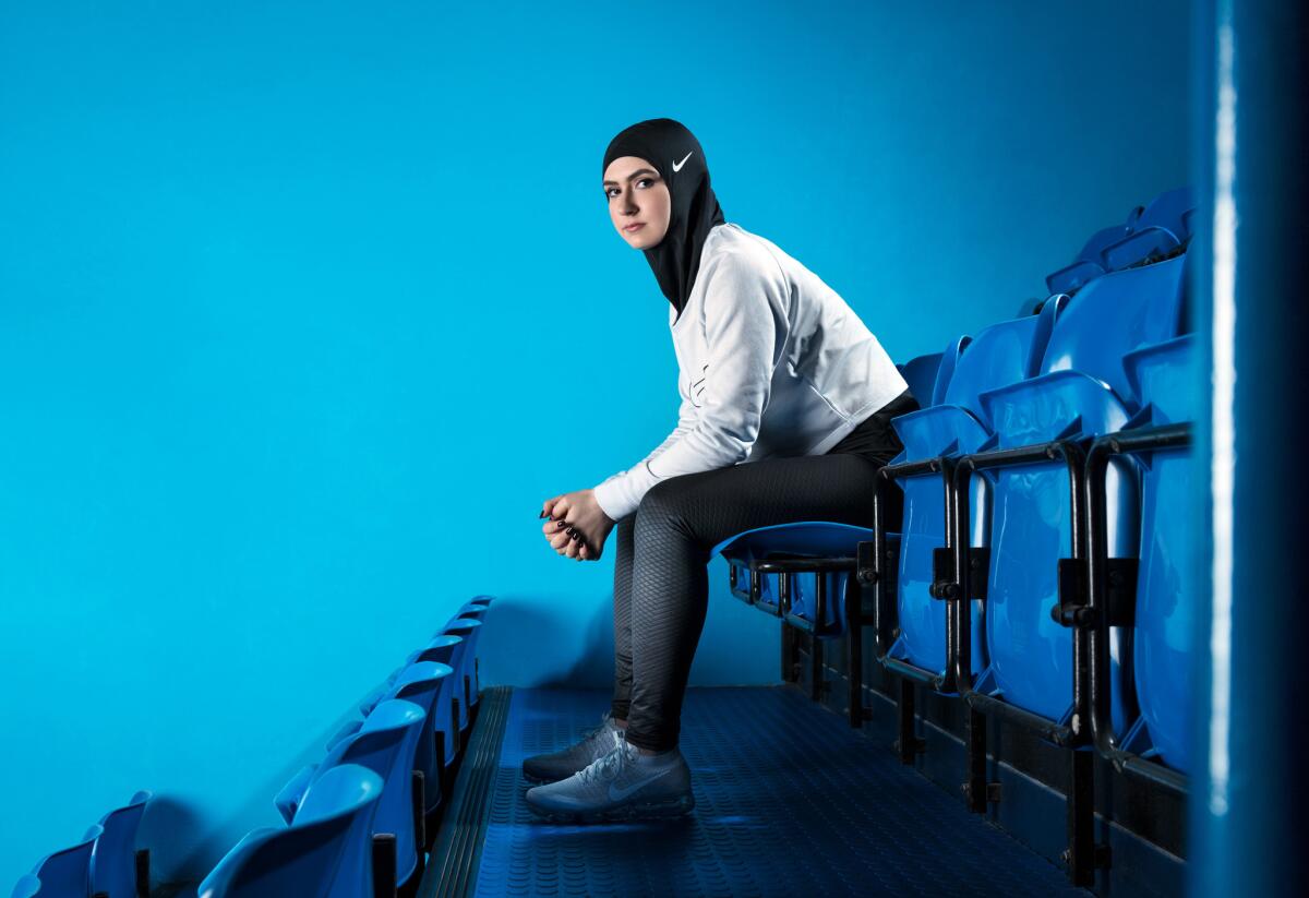 In this undated image provided by Nike, figure skater Zahra Lari model wears Nike's new hijab for Muslim female athletes. The pull-on hijab is made of light, stretchy fabric that includes tiny holes for breathability and an elongated back so it will not come untucked. It will come in three colors: black, vast grey and obsidian. Beaverton-based Nike says the hijab will be available for sale next year.